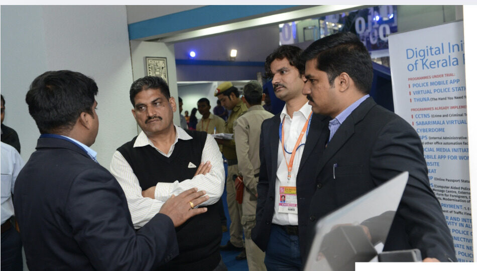 Santosh Talaghatti in discussion at a Digital Initiative of Kerala Police exhibit, featuring the Police Mobile App programme